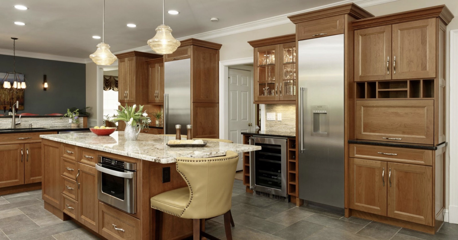 Custom kitchen remodel with stained wood cabinetry and stone island