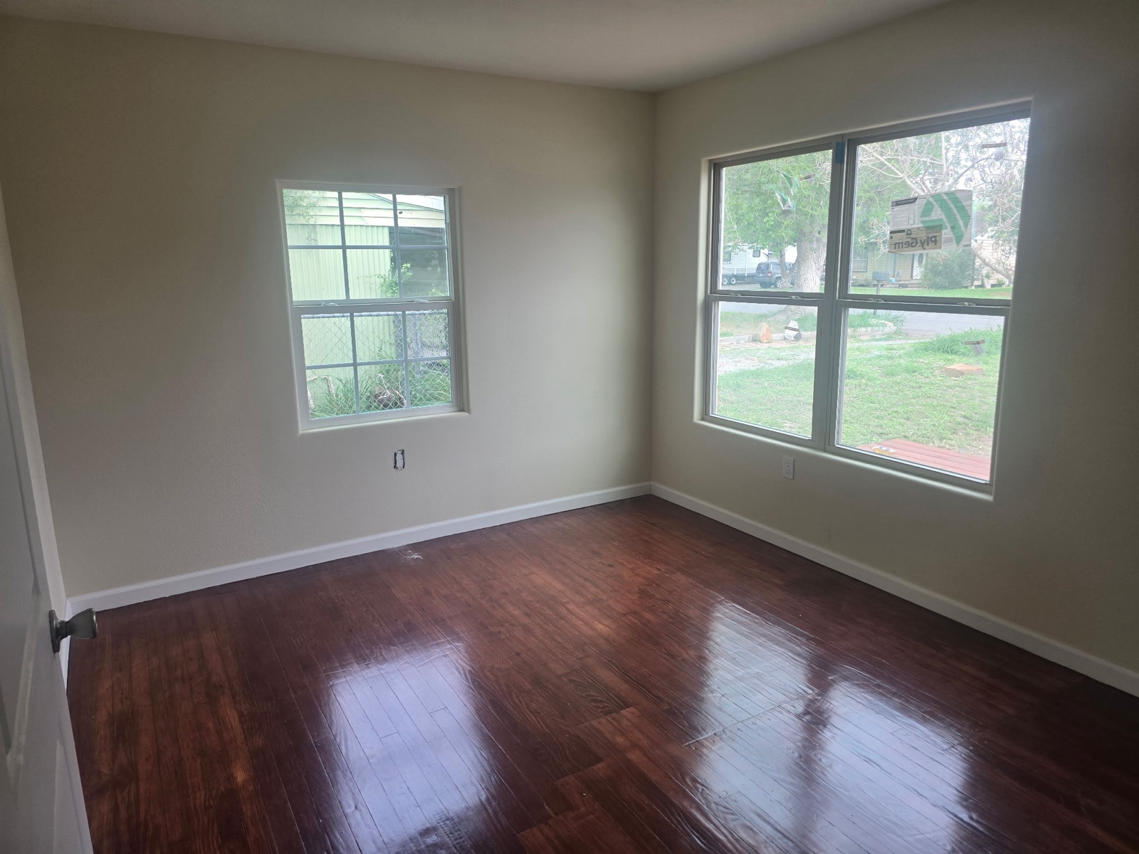 Renovated interior with refinished hardwood floors and twin windows