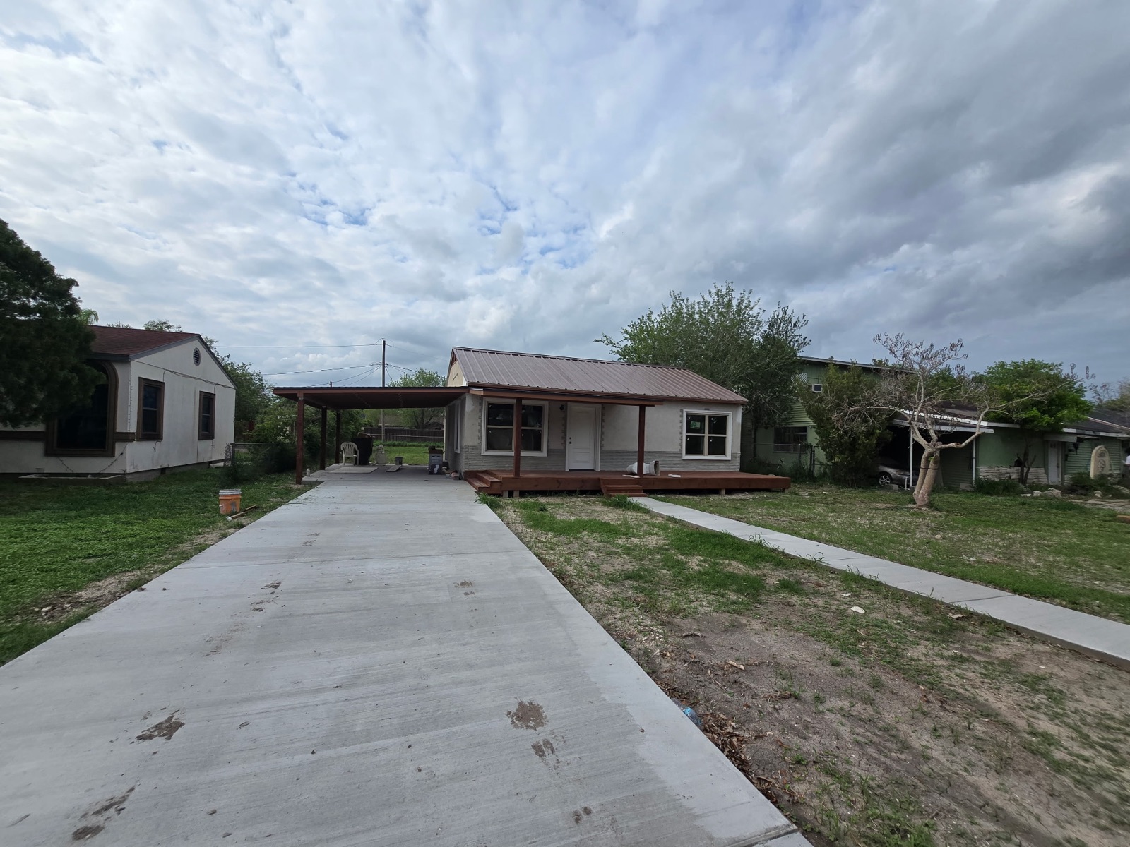 Completed single-family residence with metal roof and concrete driveway, Rio Grande Valley